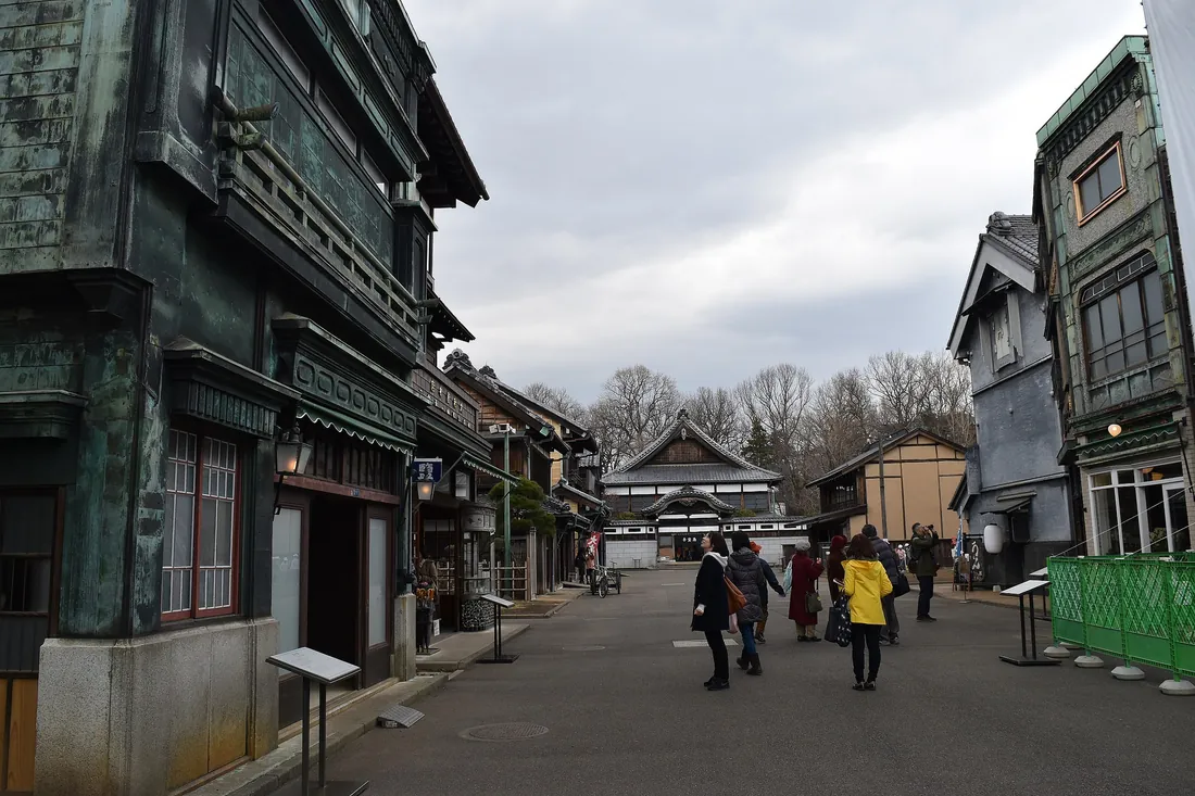 Visitors walking a street of relocated historic buildings at the Edo-Tokyo Open Air Architectural Museum in Koganei Park