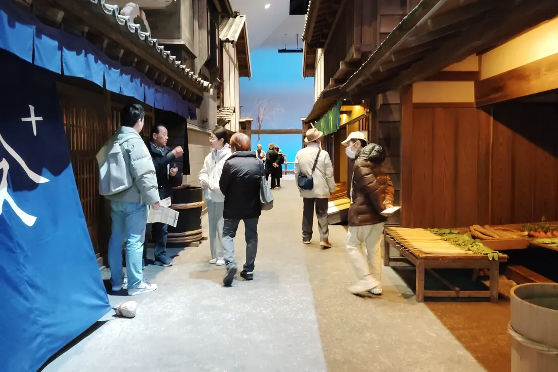 Visitors walking through the recreated 1840s street inside the Fukagawa Edo Museum in Tokyo
